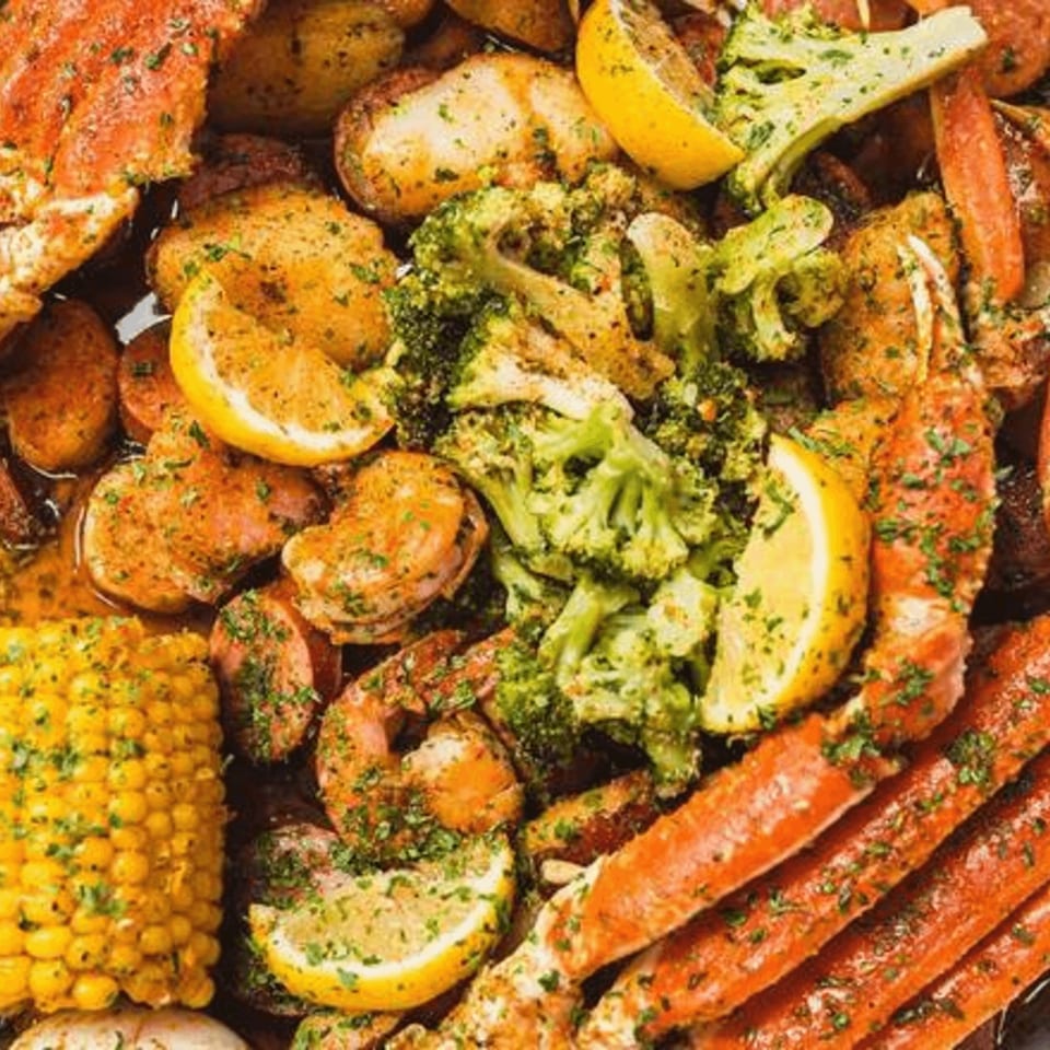 Catfish Willy's seafood boil with crab legs, shrimp, corn, potatoes, broccoli, and lemon.